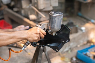 His hands are power Paint some parts of the car