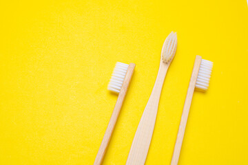 Bamboo brush on a yellow background. No plastic. Ecology. Taking care of the world around you. Toothbrush. Clean teeth. Yellow background. Copy space. of the environment.