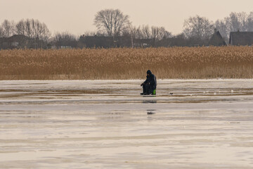 frozen river, bent and icy anglers