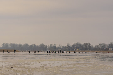 frozen river, bent and icy anglers
