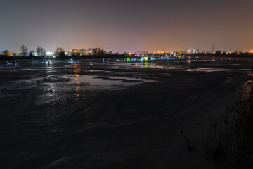 frozen river, night and ice anglers