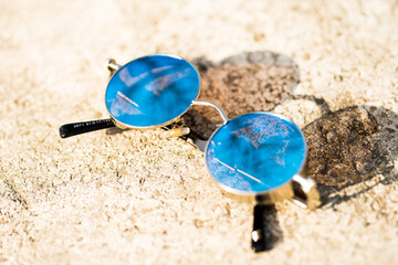 Steampunk sunglasses model with blue round lenses in a summer day closeup. Selective focus . High quality photo