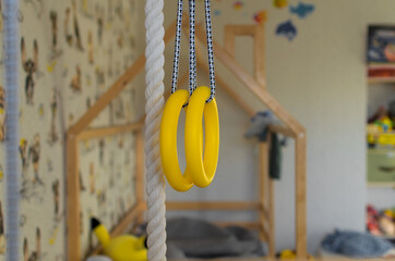 Children's wall bars, rope and athletic rings in the room, selective focus.