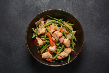 Fried vegetable mixture of carrots, broccoli ,peppers, red onion and peas with pieces of chicken fillet. Healthy food