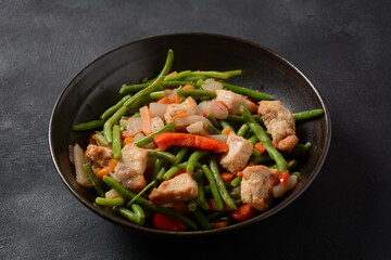 Fried vegetable mixture of carrots, broccoli ,peppers, red onion and peas with pieces of chicken fillet. Healthy food