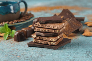 Chocolate tower. Stack of chocolate pieces. The chunks of broken chocolate. Background with chocolate.