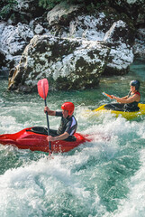 Kajakfahrer spielen mit den Kr&auml;ften der Natur im Wildwasser der Soca