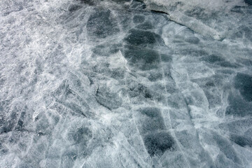 The texture of the surface of ice on a frozen lake. Natural background.