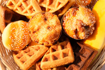 Top view waffles and cake on wood table background