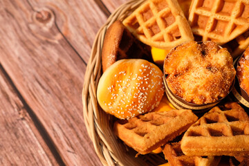 Top view waffles and cake on wood table background