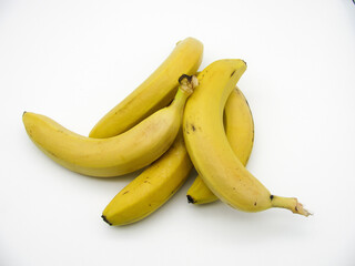 Five yellow fresh ripe bananas on a white background