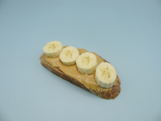 Sandwich: bread spread with peanut butter and banana slices