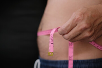 woman measuring their waist