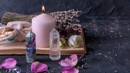 Magic still life with fluorite, quartz crystal and pink candle. Magic rocks for mystic ritual, witchcraft Wiccan or spiritual practice (healing). Meditation reiki. Ritual for love and chakra balance. - obrazy, fototapety, plakaty