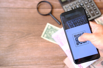 Hands holding smartphone and using qr code payment