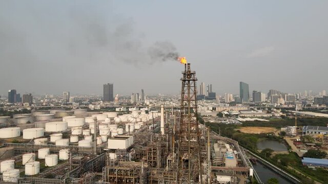 Fire on flare stack oil and gas central processing platform while burning toxic and release over pressure from process emergency shut down. environment sound.