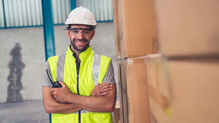 Professional industry worker close up portrait in the factory or warehouse . Production line operator or engineering looking at camera .