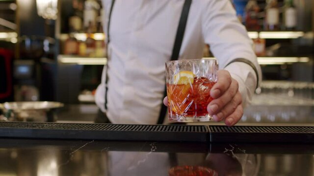bartender mixing alcoholic cocktail in bar