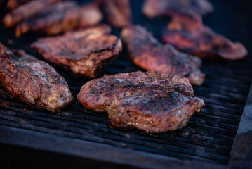 roasted chicken and pork steak with sausages. grilled meat cooked and smoked