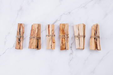 Palo Santo tree sticks on marble background - holy incense tree from Latin America. Meditation,...
