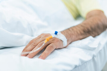 Obraz na płótnie Canvas Cropped image of IV drip on patient hand.
