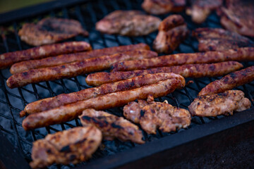roasted chicken and pork steak with sausages. grilled meat cooked and smoked
