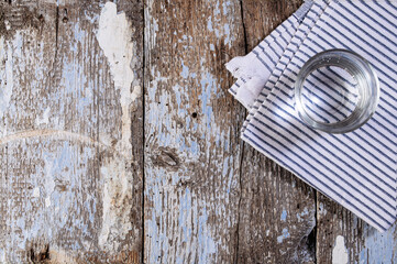 glass with water on a wooden background top view, empty space
