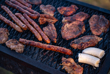 roasted chicken and pork steak with sausages. grilled meat cooked and smoked