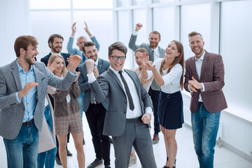 Fototapeta premium triumphant business team congratulating their leader. success concept