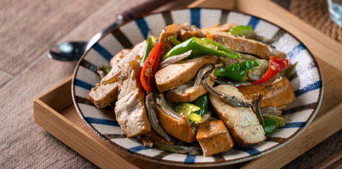 Homemade stir-fried dried beancurd with dried fish and green chili.