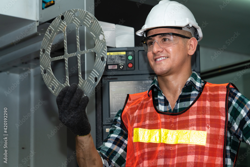 Poster smart factory job worker looking at machine part in manufacturing workshop . industry and engineerin