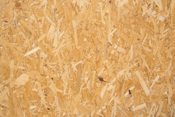 Wooden background, fiberboard or chipboard pattern, pressed wood shavings backdrop, wall made from wood