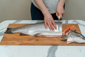 trout carcass lying on a wooden board. view from above. place for inscription