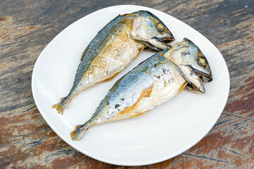fried Mackerels on old wooden table