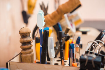 Tools to create leather goods in a wooden stand