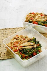 Nasi Gonde Sisit Ayam or known as Nasi Campur Bali, a Balinese Mix Rice made with seasoned green vegetables, shredded chicken, fried salted fish and spicy fresh chili sauce. Selective focus  