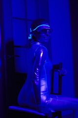 Fototapeta na wymiar Cyberpunk style portrait of beautiful young woman in futuristic costume.