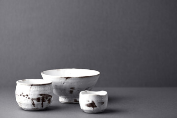 Traditional, handcrafted ceramic on gray background. Soft focus. Copy space.