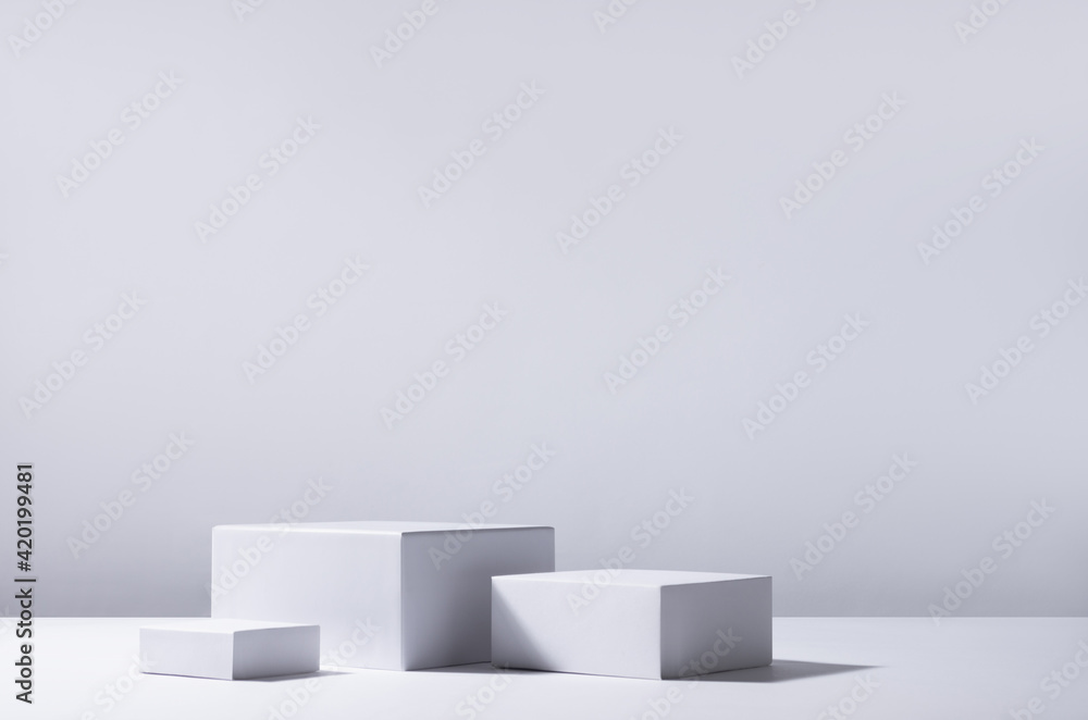 Poster elegant abstract set of white podiums in sunlight with shadow on white background for product displa