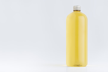 Transparent plastic tall bottle with orange drink, cooking oil or cosmetic produce, silver cap mockup on white background. Template for portfolio, design, branding identity.