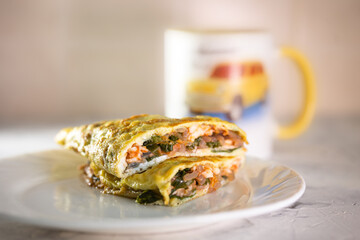 stuffed omelet on a white plate. healthy food breakfast