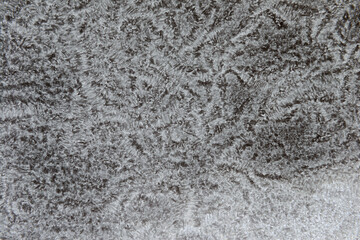 Fototapeta premium Frosty pattern of frozen snow on the surface