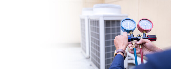 Technician is checking air conditioner ,measuring equipment for filling air conditioners.
