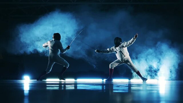 Fencing match between two men shown in slow motion