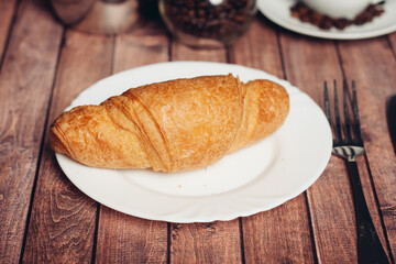croissant in a plate on the table kitchenware breakfast meal dessert