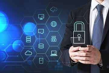 Businessman with smartphone, blue hologram glowing information security icons. Concept of cyber security and data storage. Padlock and business symbols.