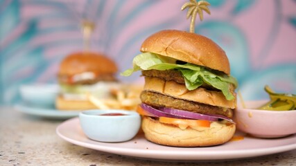 Close up of vegan burger served with sweet potato fries and ketchup. Healthy delicious plant-based meals