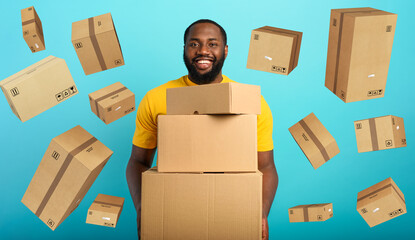 Happy boy receives a lot of packages from online shop order. Blue background.