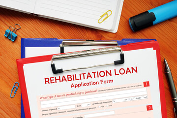 Man wearing blue business suit and showing financial document with written text REHABILITATION LOAN...