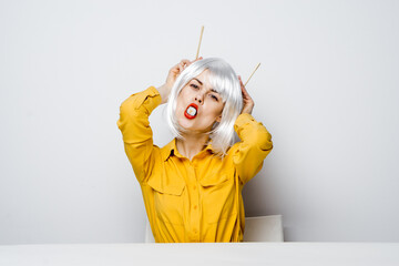 attractive woman in white wig chopsticks sushi rolls restaurant